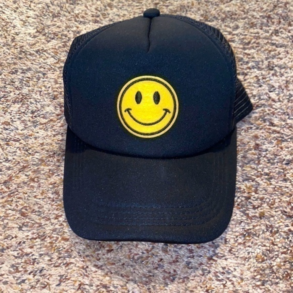 Black smiley face trucker hat